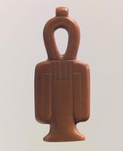 A red stone amulet shaped like a column with a looped top and two loops hanging at the sides