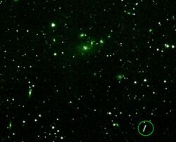 Asteroid Maria passing near a cluster of galaxies