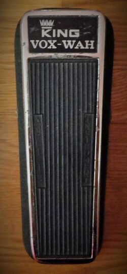 A color image of a 1968 King Vox Wah pedal. The foot pedal is black with chrome accents and has a "King Vox Wah" label on the top.