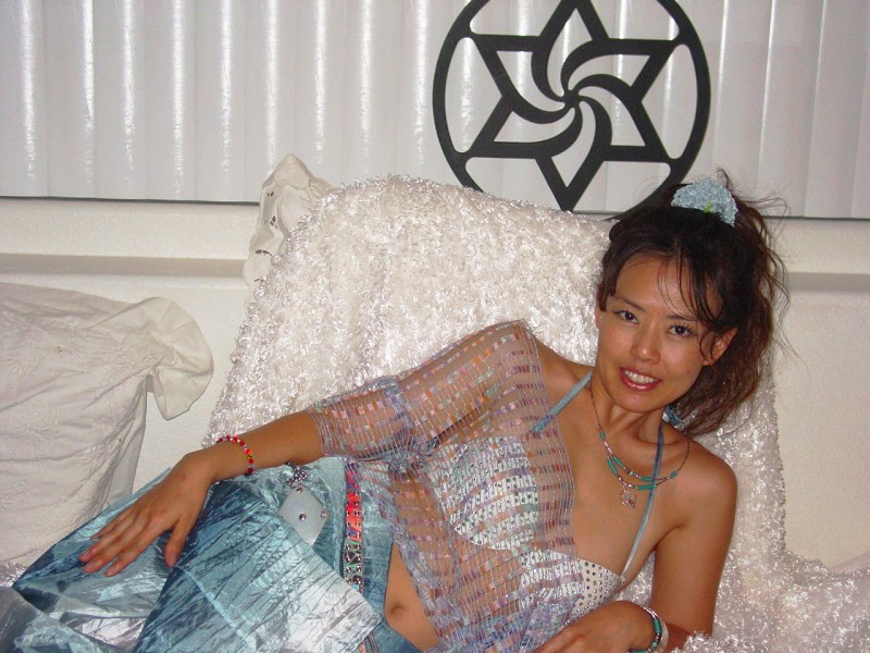 File:Lady on bed adorned with Raëlian symbol.jpg