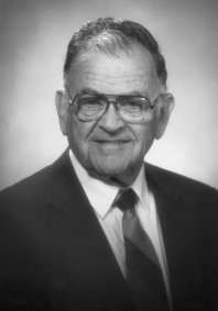 Black and white photograph Prof. Freund in a jacket & tie, and wearing eyeglasses.
