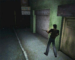 A video game screenshot that is a digital representation of a dark town street. A man with his back to the viewer holds a rifle as he walks along the side of a green building.