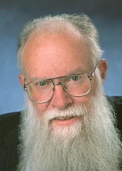 Full face portrait, showing mature glasses-wearing adult male with white hair and a full white mustache and long beard