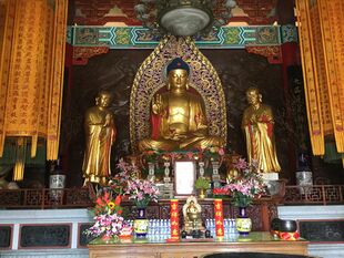 Buddha image, with images of two disciples at the sides.