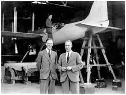 photograph of the aircraft along with its designer and test pilot