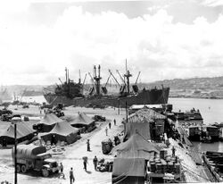 SC 204192 - The “Spar Hitch”, C1-M-AVI, captained by Carl, E. Peterson, New York, N.Y., in background, is the first big ship to enter Naha Harbor, Okinawa.jpg
