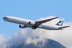 Aircraft takeoff. Side view of aircraft ascending, with landing gear doors open