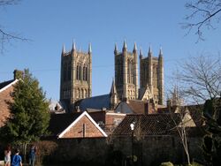 A view of the city of Lincoln showing the three towers of the cathedral rising high above the town