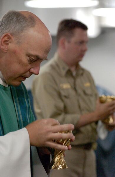 File:US Navy 030727-N-8148A-100 Lt. Richard House, Assistant Command Chaplain, (left) and Lt. Chris Chandler offer Holy Communion during the first underway Roman Catholic Mass aboard USS Ronald Reagan (CVN 76).jpg