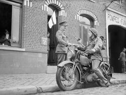 A motorcycle despatch rider delivers a message to the signals office of 1st Border Regiment at Orchies, France, 13 October 1939. O129.jpg