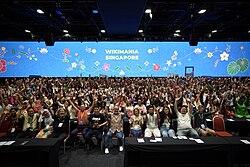 Group photo with raised hands Wikimania 2023.jpg