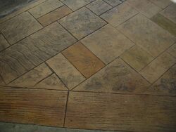 Irregular sized and tiled stamped concrete with a stone and wood-grain like textures