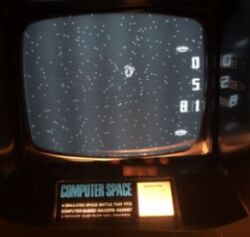 Photograph of gameplay, with white dots on a black screen and instructions below