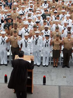 US Navy 090528-N-3207B-034 Sailors, Marines, Soldiers and Airmen recite the pledge of allegiance during a naturalization ceremony at the USS Midway Museum.jpg