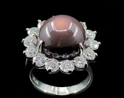 An 11.26 ct. deep purple quahog pearl, diamond, and platinum ring