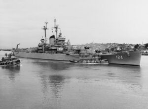 USS Rochester (CA-124) with tugs at the Mare Island Naval Shipyard on 20 September 1953 (NH 84584).jpg