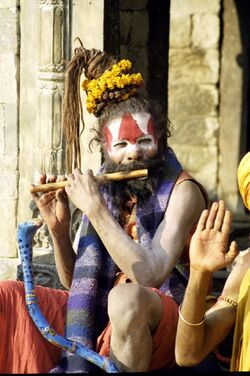 A sadhu playing flute, Benaras.jpg