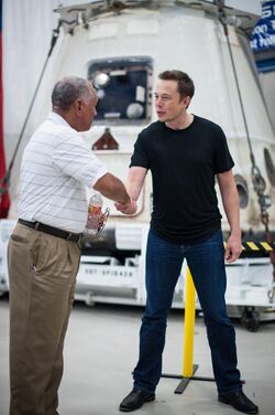 Charles Bolden congratulates SpaceX CEO and Chief Designer Elon Musk in front of the historic Dragon capsule.jpg