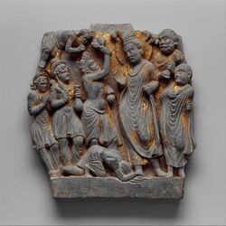 In this panel Sumedha appears three times: first, standing before the Buddha Dipankara offering flowers; second, prostrating before the Buddha spreading his matted locks over mud; and third, flying in the upper left of the panel in a gesture of veneration.
