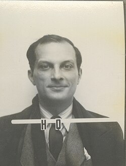A mug shot style ID photo, with the serial H 0