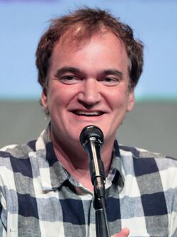 Quentin Tarantino sitting down, smiling