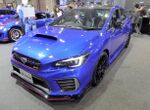 Subaru WRX STI S208, a limited-production high-performance automobile. This is a front view of the car, showing its blue color, hood scoop, and nameplate.
