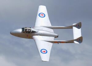 De Havilland DH115 Vampire banking with the sun reflecting off its silver wings (cropped).jpg