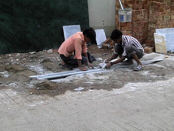 Workers cutting marble without any protective gear. Photo taken in Indore, India