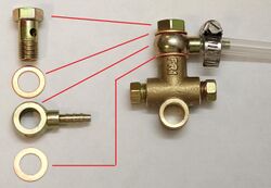 An example of typical banjo fitting components (left) with an identical fitting connecting a hose to a tee fitting.