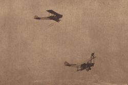 In Atlantic City Ormer Locklear of Locklear's Flying Circus clings to one plane waiting for a 2nd plane trailing a rope ladder.jpg