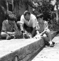 Ernest Hemingway with sons Patrick and Gregory with kittens in Finca Vigia, Cuba.jpg