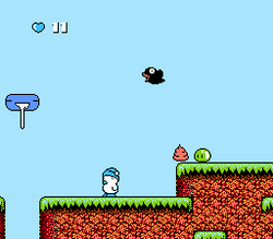 A screenshot from the Japanese version of the game, named Hebereke: The player (Hebe) is shown, alongside birds dropping feces.
