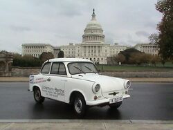 White Trabant with lettering, with the Capitol Building in the background