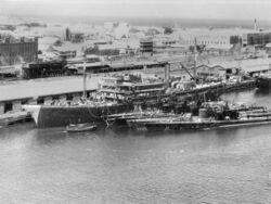 USS Holland (AS-3) tending submarines at Fremantle, Australia, on 5 March 1942 (AWM 302625).jpg