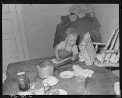Son of Charles B. Lewis, miner, playing around kitchen table in home in company housing project. Union Pacific Coal... - NARA - 540564.jpg