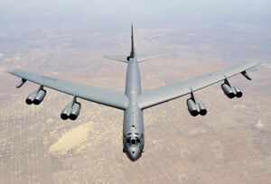 Aerial top/side view of gray B-52H flying over Texas