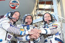 Expedition 37 backup crew members in front of the Soyuz TMA spacecraft mock-up in Star City, Russia.jpg