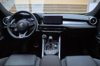 Dashboard of the car with front airbags, digital gauges, a satellite navigation touchscreen, automatic gearbox, electronic handbrake, button-operated heater and fan controls, a USB port, and an unlabeled rotary dial