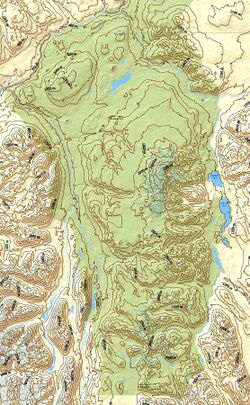 A yellow and green map with contour lines depicting a mountainous environment.