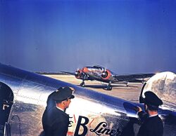Braniff Airline Pilots Watching a Lockheed 12A Electra Junior.jpg