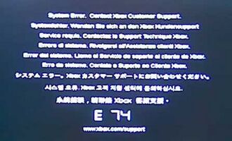 The error code E74. Above the large E 74 code is the message "System Error. Contact Xbox Customer Support." repeated in different languages.