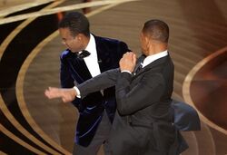 Chris Rock is slapped by Will Smith.