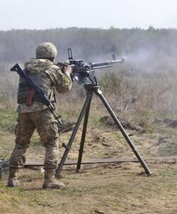 A soldier with the Ukrainian Land Forces fires a Degtyaryov-Shpagin Large-Caliber heavy machine gun.jpg