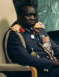 Idi Amin stands in military uniform