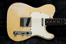 Telecaster body, showing absence of contouring and general symmetry apart from cutaway, two single-coil pickups and controls