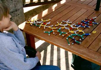 A boy with Asperger's playing with molecular structures.