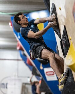 A climber bouldering in a climbing gym