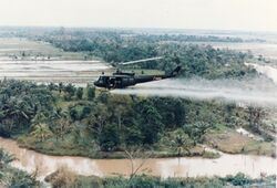 US-Huey-helicopter-spraying-Agent-Orange-in-Vietnam.jpg