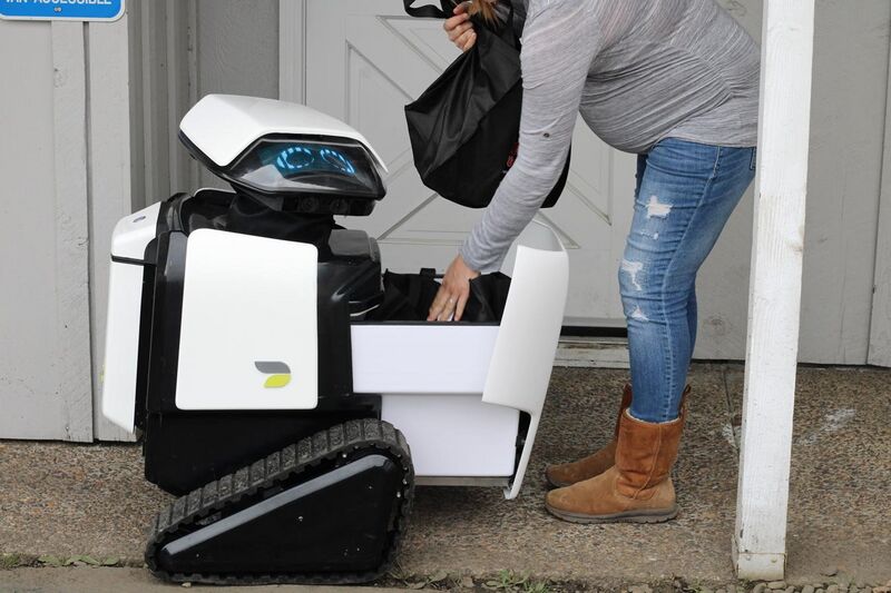 File:Woman Takes Groceries from Dax Delivery Robot.jpg