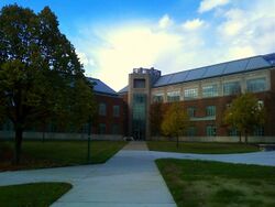 Picture of a three-story building with walkways on an autumn day